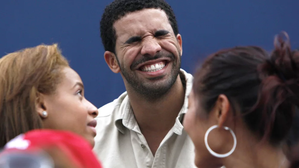 canadian-rapper-drake-laughs-as-he-watches-serena-williams-of-the-u-s-play-samantha-stosur-of-australia-in-toronto-2