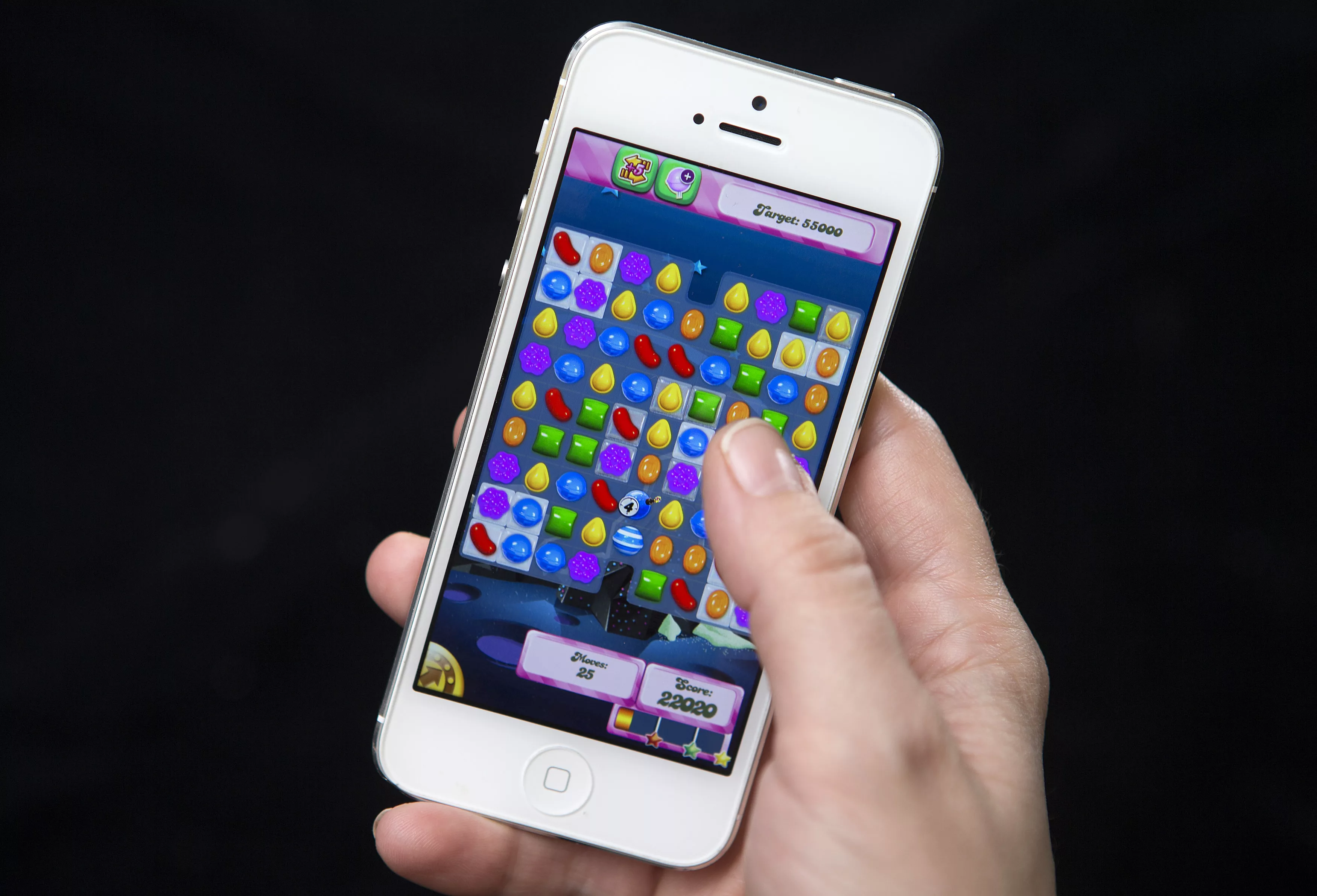 a-woman-poses-for-a-photo-illustration-with-an-iphone-as-she-plays-candy-crush-in-new-york