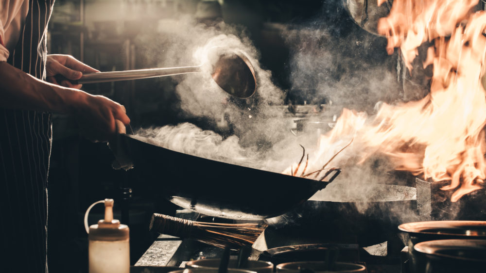 chef-stir-fry-busy-cooking-in-kitchen