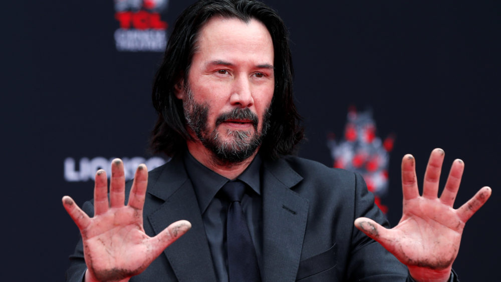 actor-keanu-reeves-puts-his-hand-and-footprints-in-cement-in-los-angeles