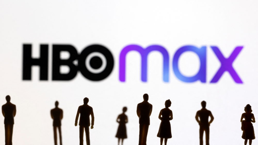 toy-figures-of-people-are-seen-in-front-of-the-displayed-hbo-max-logo-in-this-illustration