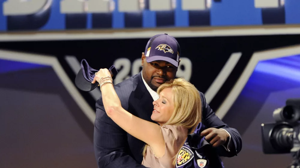 offensive-tackle-oher-of-university-of-mississippi-embraces-an-unidentified-friend-on-stage-after-being-selected-by-baltimore-ravens-as-23rd-overall-pick-in-2009-nfl-draft-in-new-york
