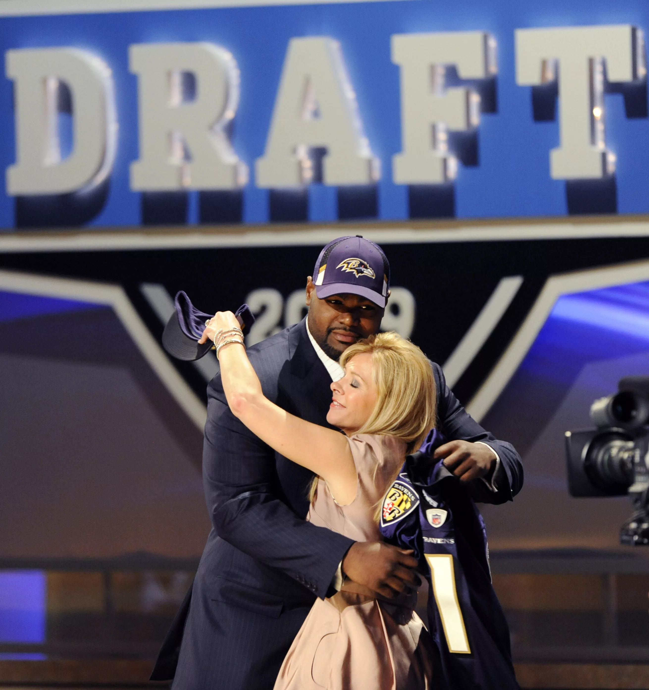 offensive-tackle-oher-of-university-of-mississippi-embraces-an-unidentified-friend-on-stage-after-being-selected-by-baltimore-ravens-as-23rd-overall-pick-in-2009-nfl-draft-in-new-york