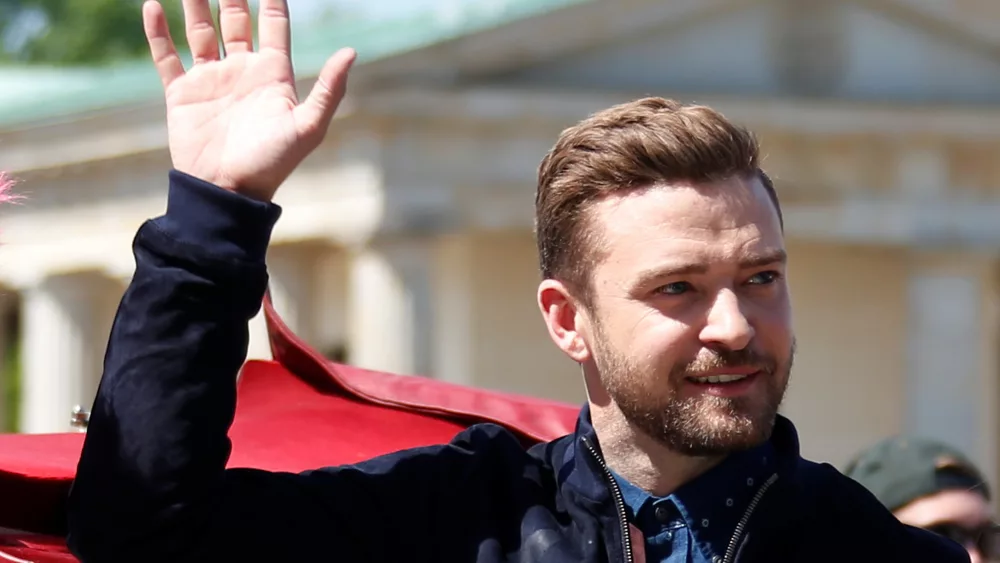 actor-and-singe-timberlake-waves-during-a-photocall-to-promote-the-movie-trolls-in-front-of-the-brandenburg-gate-in-berlin