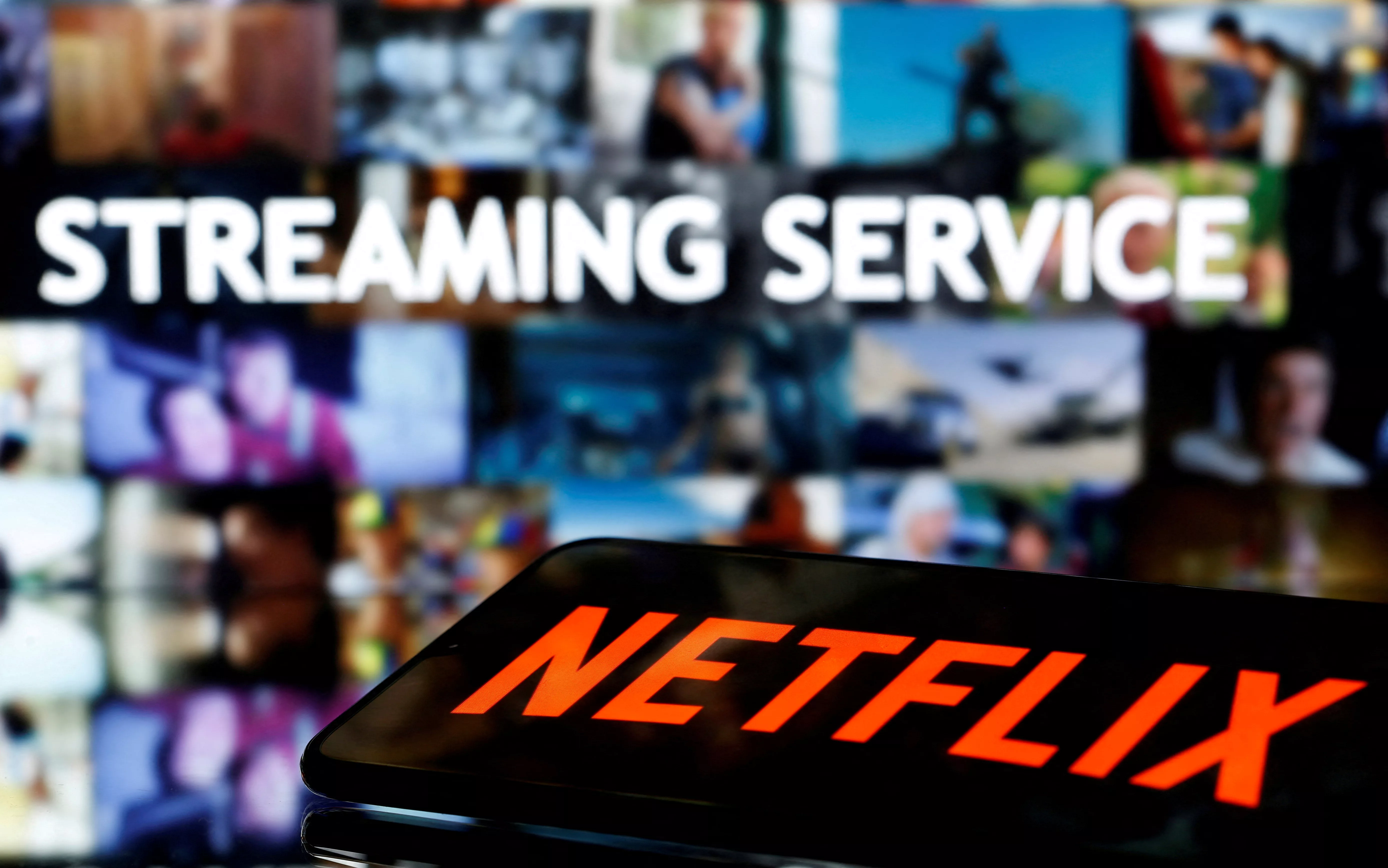 file-photo-a-smartphone-with-the-netflix-logo-lies-in-front-of-displayed-streaming-service-words-in-this-illustration-2
