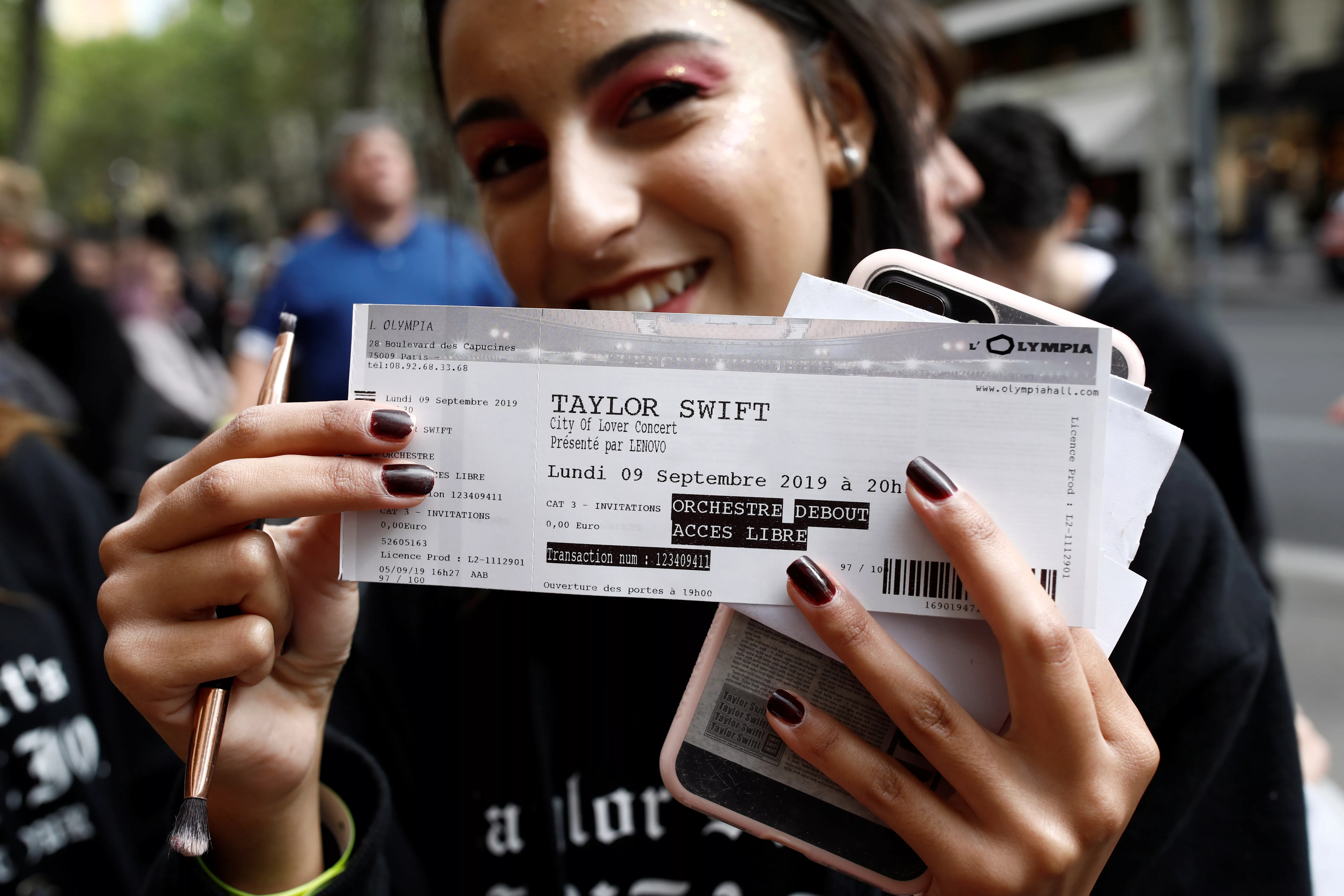 a-fan-of-taylor-swift-holds-up-her-ticket-prior-to-a-concert-performance-at-the-olympia-theatre-in-paris