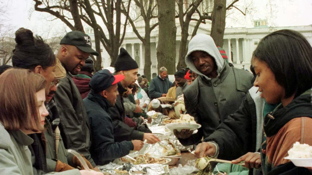 with-the-u-s-capitol-for-a-background-the-hungry-and-homeless-r-line-up-to-receive-their-thanksg