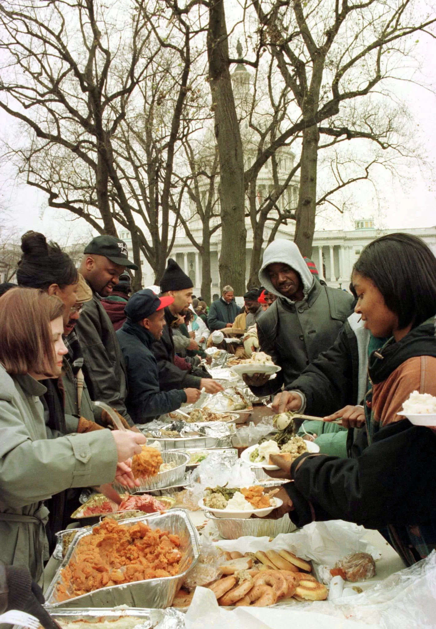 with-the-u-s-capitol-for-a-background-the-hungry-and-homeless-r-line-up-to-receive-their-thanksg