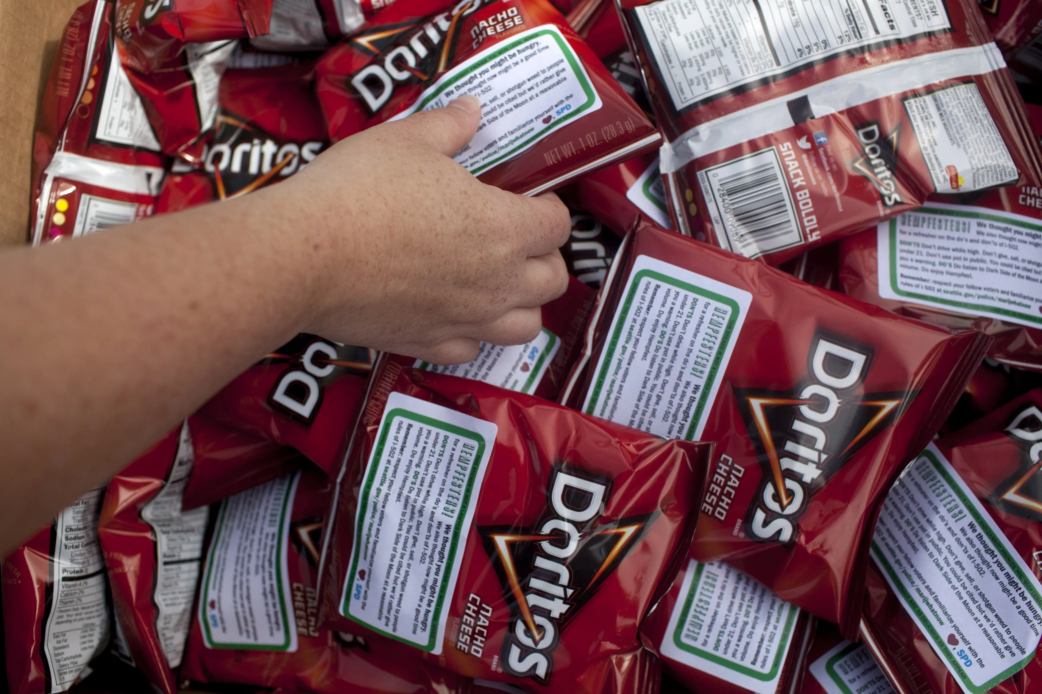 seattle-police-department-officers-hand-out-bags-of-doritos-to-festival-goers-during-the-hempfest-rally-in-seattle