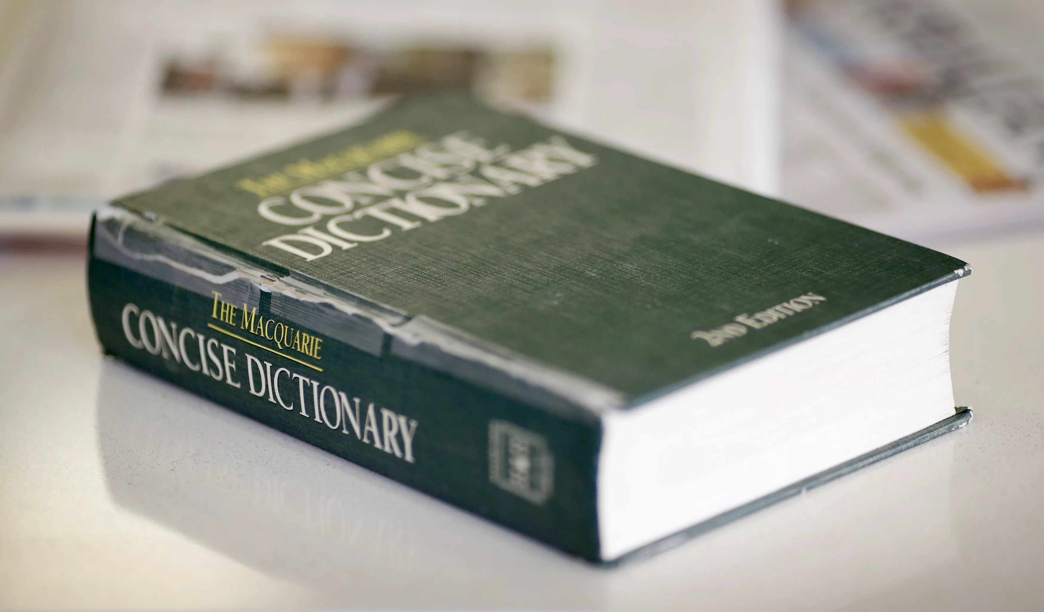 a-photo-illustration-shows-a-2nd-edition-copy-of-the-macquarie-concise-dictionaryon-a-coffee-table-in-sydney