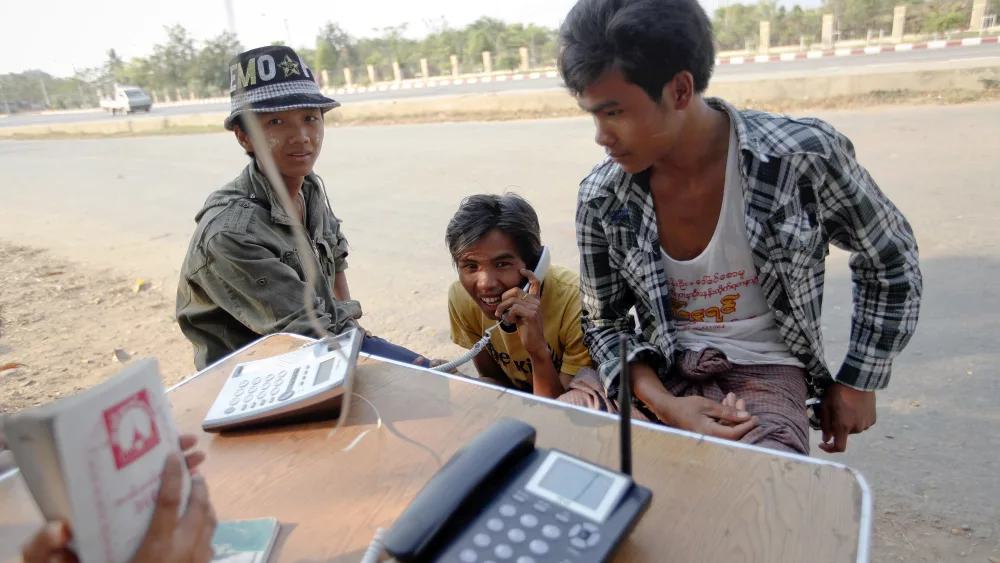 a-man-uses-a-phone-at-a-public-phone-shop-in-naypyitaw