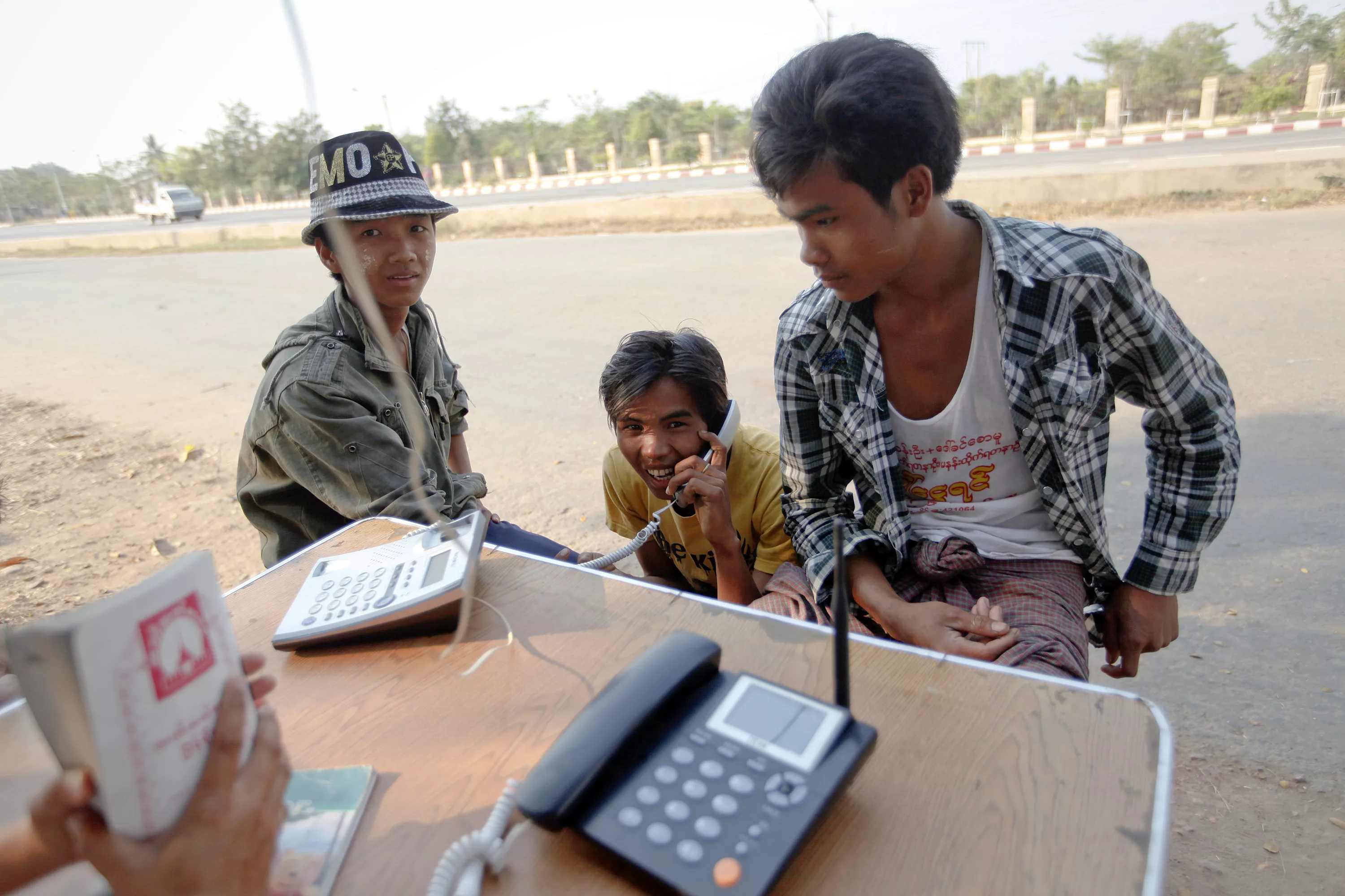 a-man-uses-a-phone-at-a-public-phone-shop-in-naypyitaw