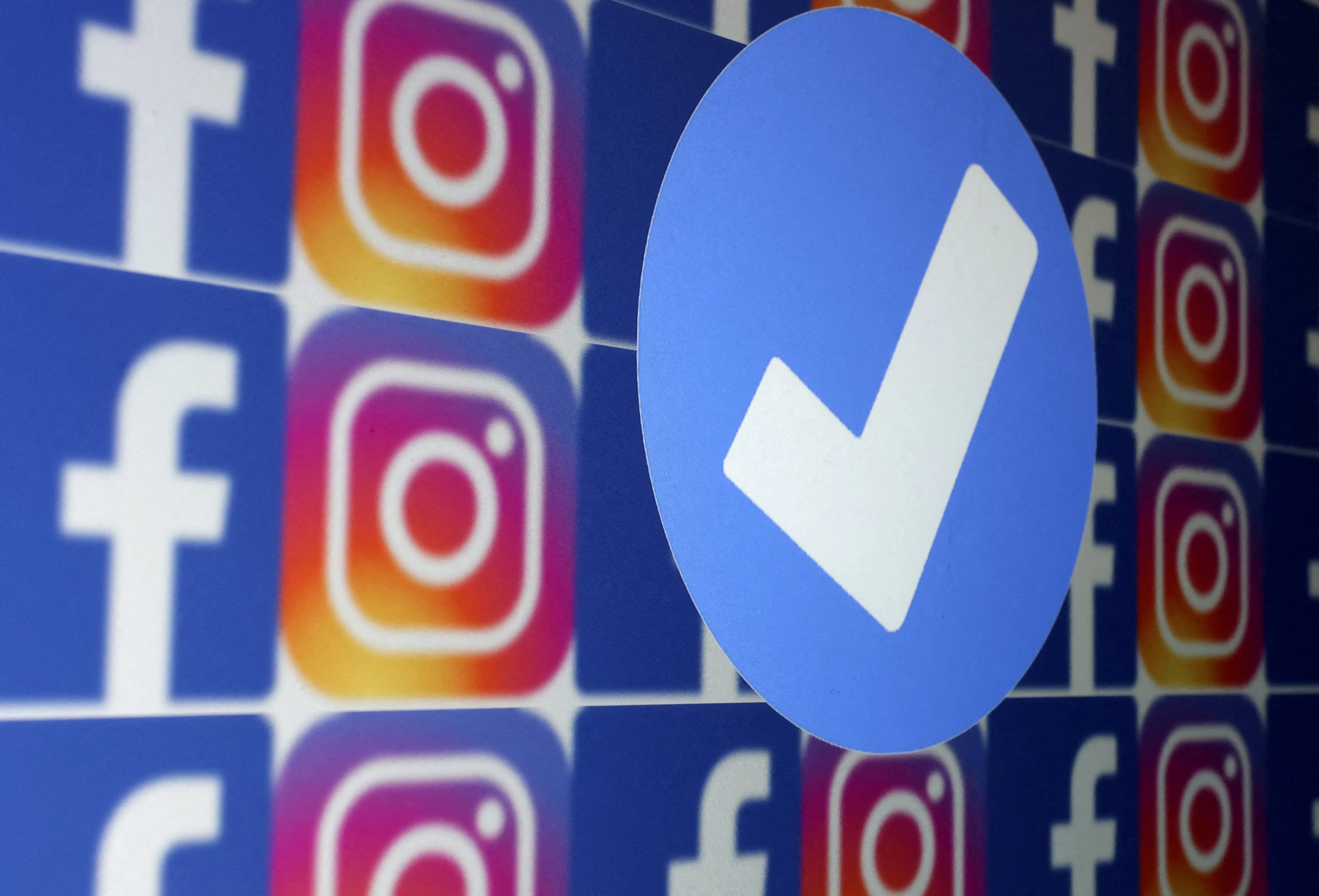 file-photo-illustration-shows-blue-verification-badge-facebook-and-instagram-logos