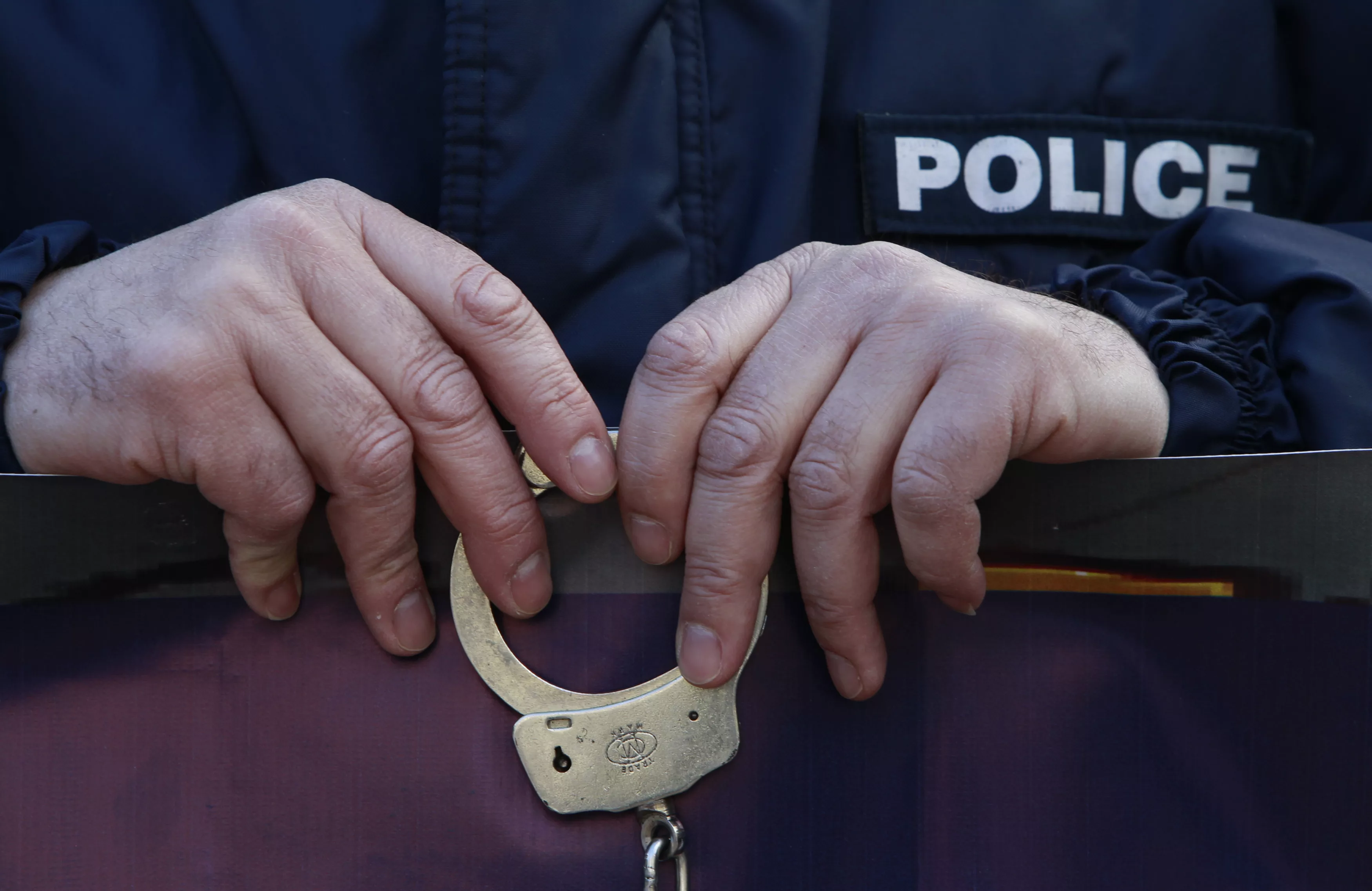 a-policeman-holds-handcuffs-as-he-protests-during-a-rally-in-athens
