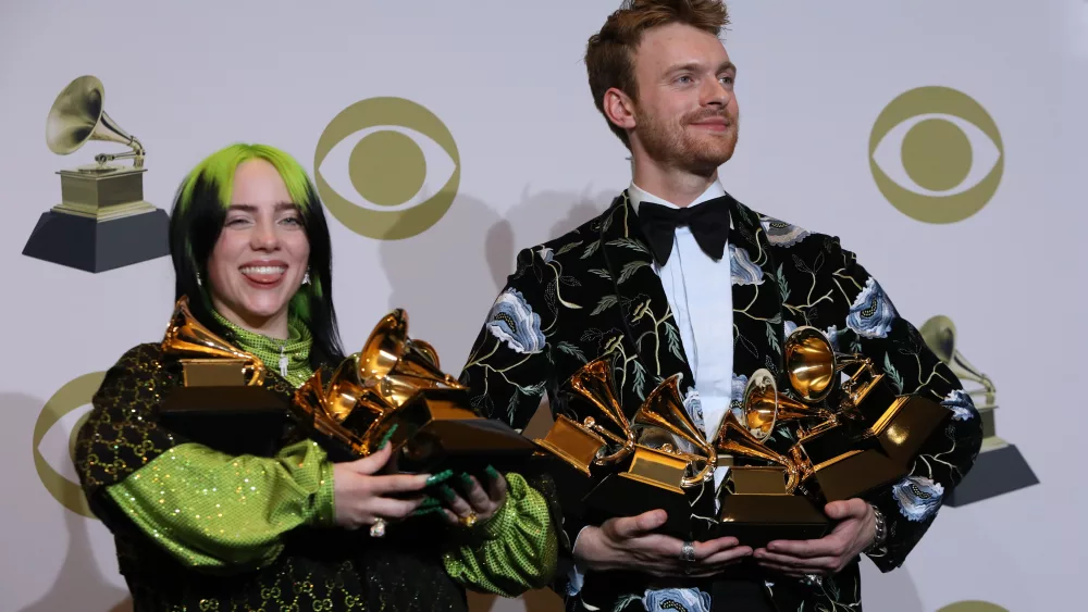 62nd-grammy-awards-photo-room-los-angeles-california-u-s-january-26-2020-billie-eilish-and-finneas-oconnell-pose-backstage-with-her-awards
