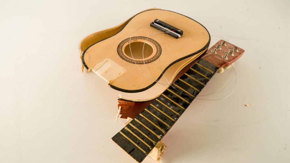 close-up-of-broken-guitar