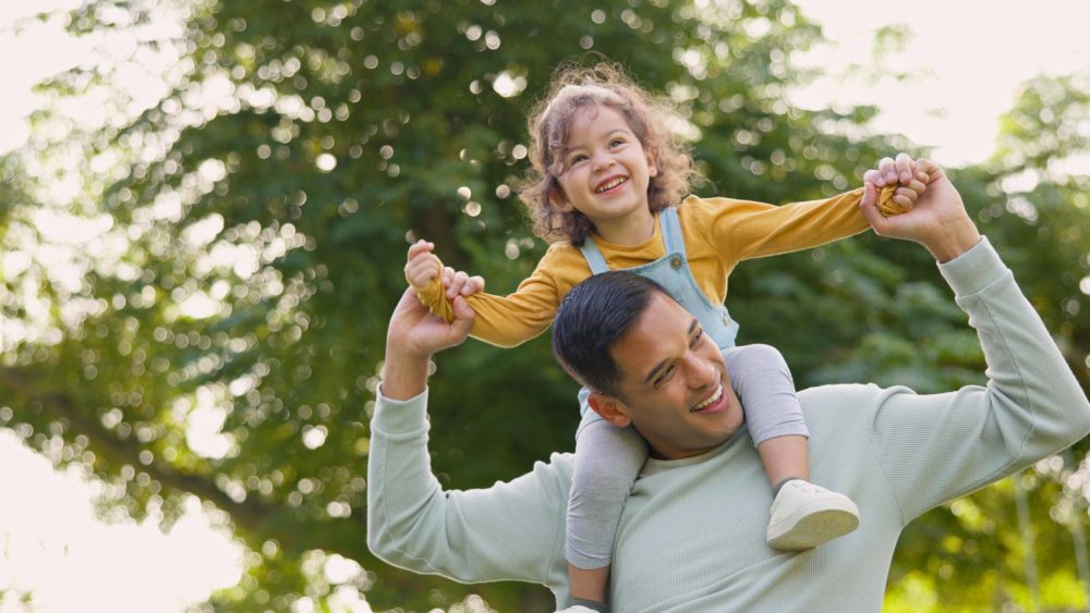 happy-piggyback-and-father-with-girl-in-nature-bonding-and-having-fun-smile-dad-and-carrying-child-on-shoulders-play-and-enjoying-quality-family-time-together-outdoor-in-park-with-love-and-care