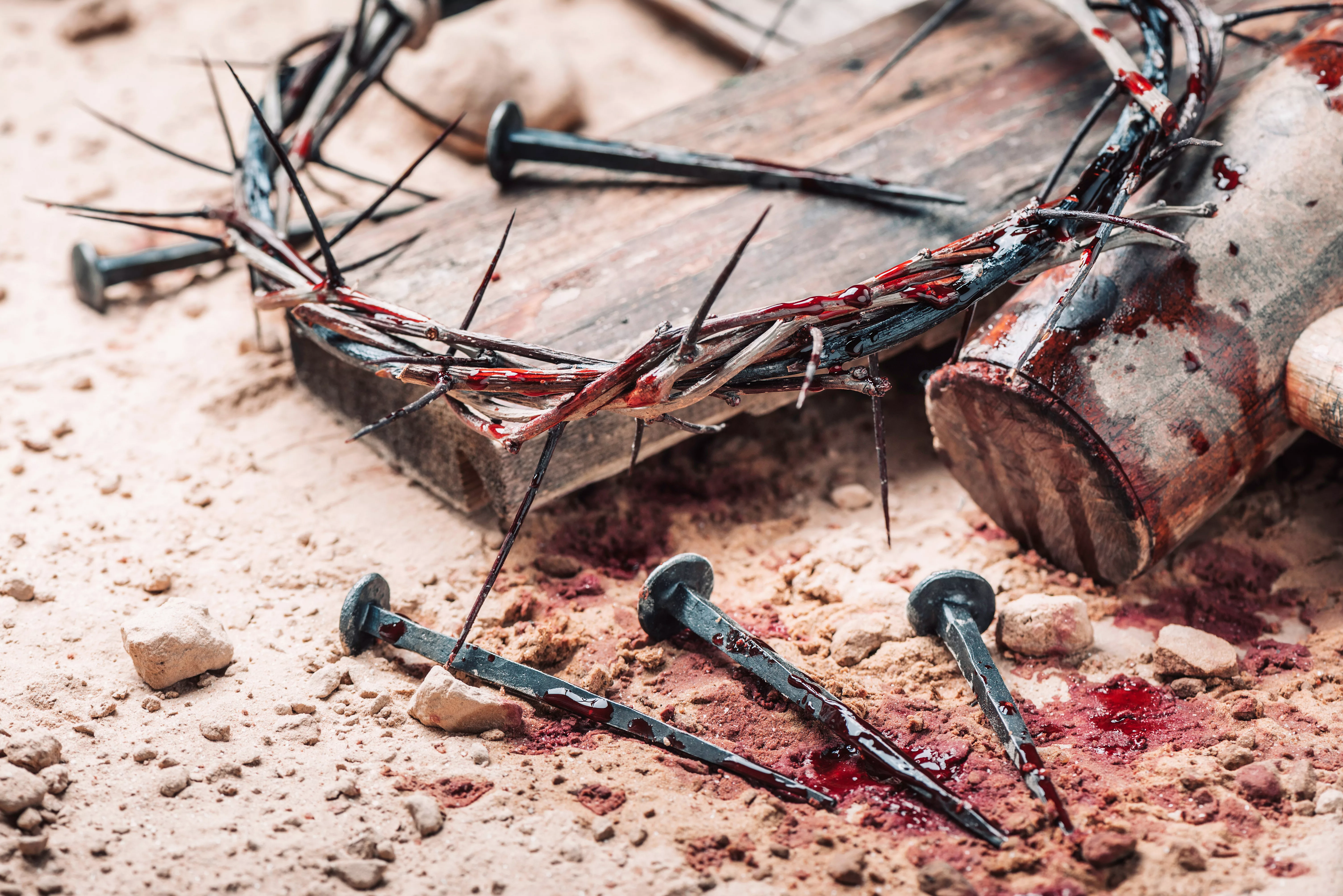 old-wooden-cross-hammer-bloody-nails-and-crown-of-thorns-on-ground-banner-copy-space-good-friday-passion-crucifixion-of-jesus-christ-christian-easter-holiday-gospel-salvation