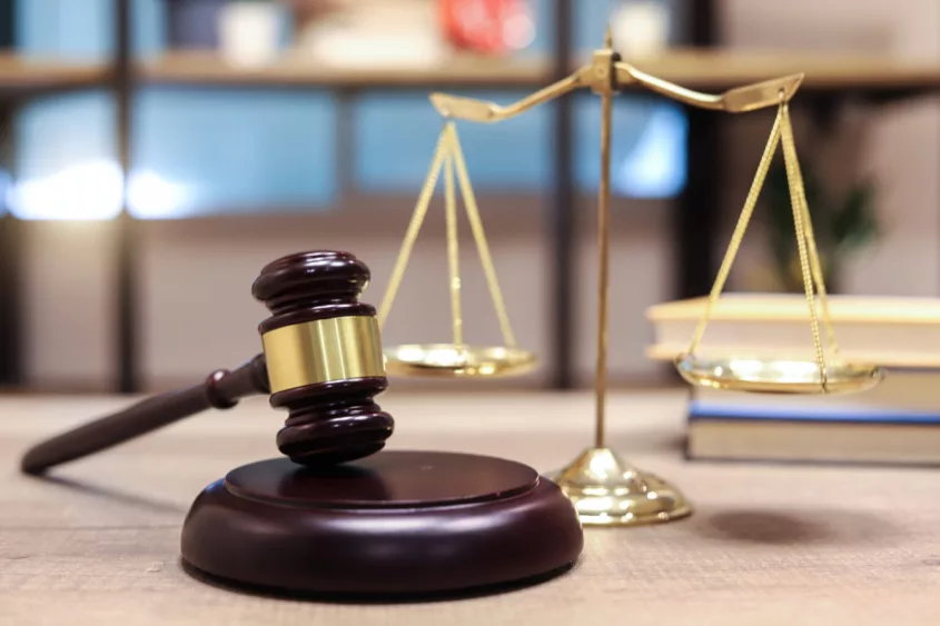 justice-scales-and-books-and-wooden-gavel