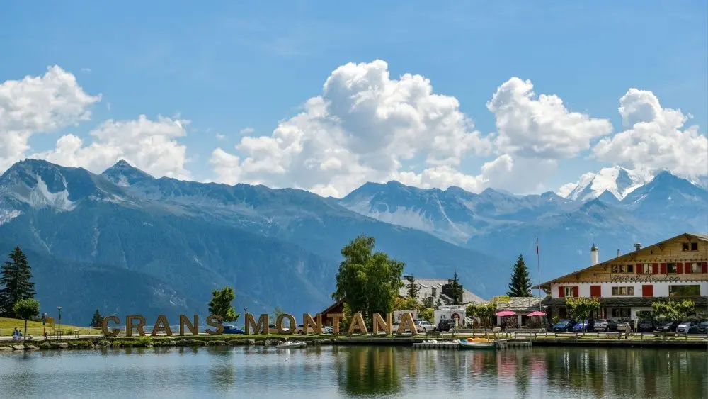 Big letters near lake spelling out Crans Montana in Switzerland during August 2020 Crans-Montana^ Switzerland - August 10^ 2020