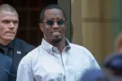 Sean “Diddy” Combs exiting the Crosby Street Hotel and heading to a waiting line of black SUV's surrounded by paparazzi and flanked by security. Lower Manhattan NYC^ New York / USA - July 24^ 2019