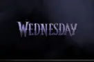 TV on black wall. TV screen playing Netflix series 'Wednesday' trailer
