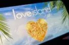 '2025 Love Island'' shown on a smart phone. is a reality dating show that originated in the UK. The premise involves a group of singles living together in a luxurious villa^ where they couple up Toronto^ Canada - June 5