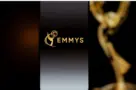 Emmys logo displayed on a smartphone screen with a blurred gold award statuette in the background^ television industry awards and digital streaming concept. Kaunas^ Lithuania - 2026 March 24