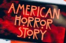 Screensaver with the 'American horror story' logo on a smartphone on toned background