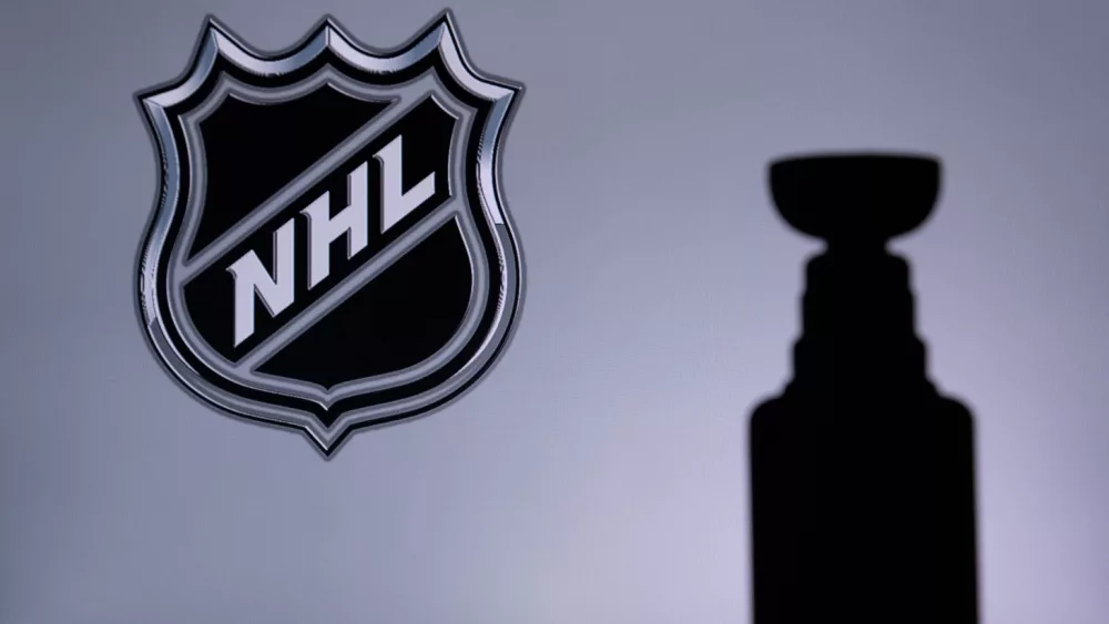 National Hockey League; Logo of NHL club on the screen. Stenley Cup Trophy Silhouette.