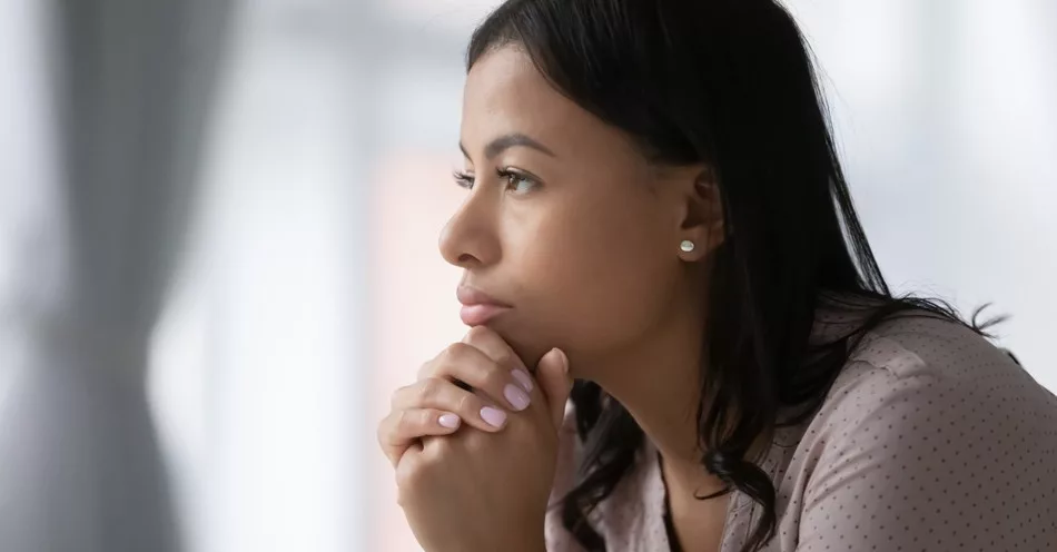 12936-woman-deep-in-thought-gazing-out-window-getty362560