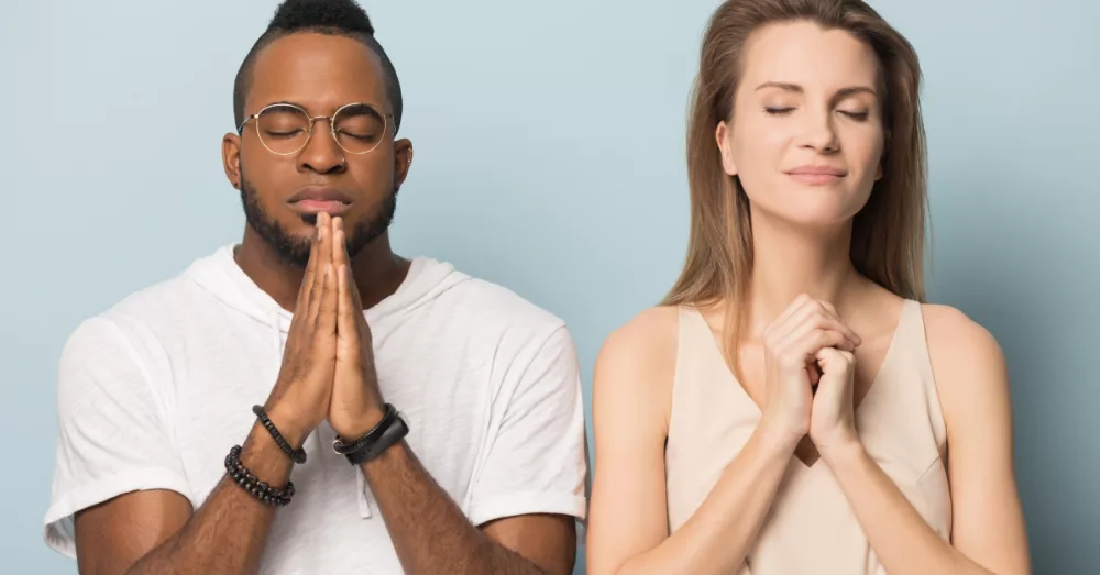 12746-man-and-woman-standing-in-prayer-eyes-closed750651