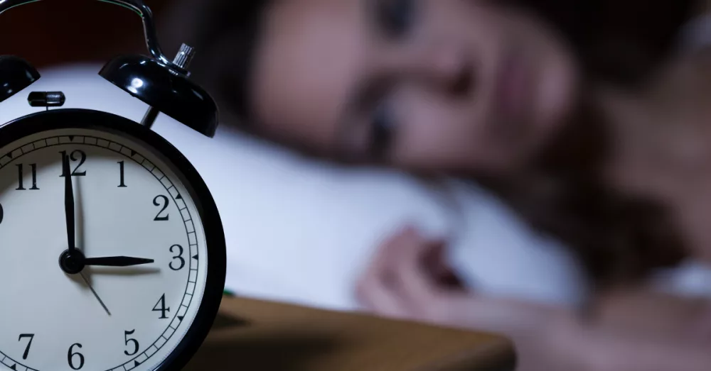 5422-woman-awake-sleepless-clock-gettyimages-atarz378920