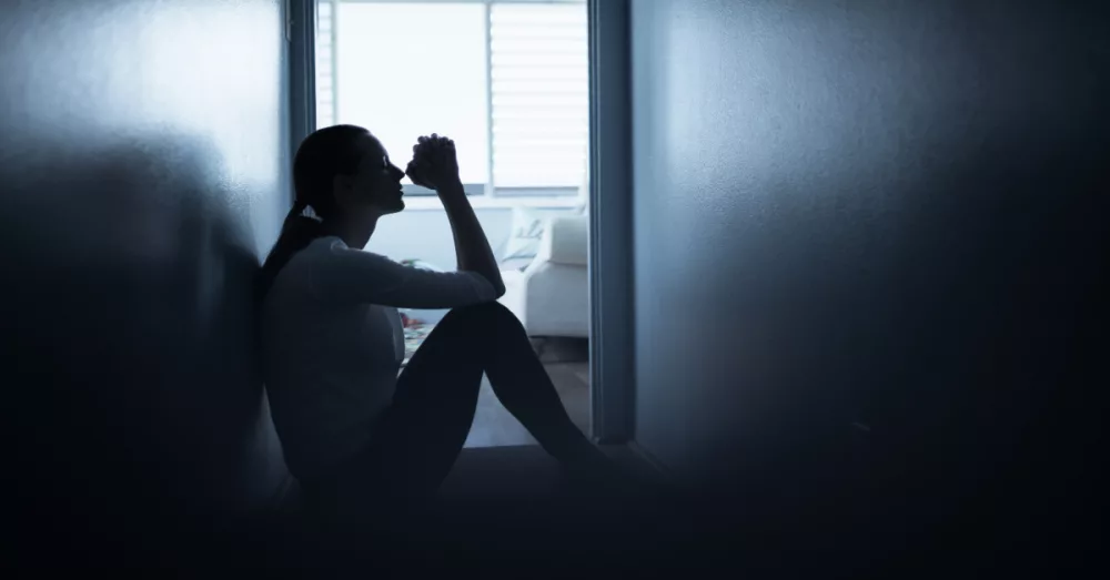 21968-woman-praying-in-hall-gettyimages-kieferpix173334