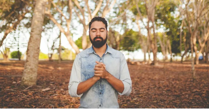 5647-man-praying-in-park-naassom-azevedo-unsplash829283