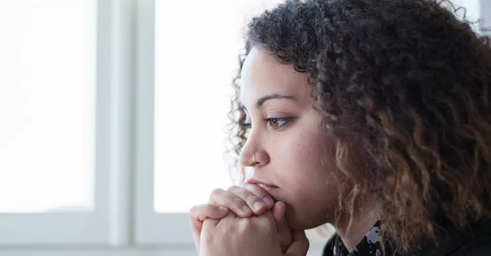 7218-woman-in-deep-thought-upset-by-window-gettyim618775