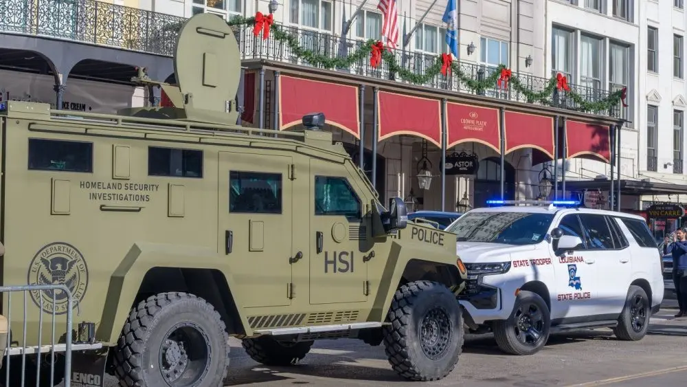 City police^ state police and Homeland Security officers^ and an armored vehicle and state patrol vehicle on Canal Street near the entrance to Bourbon Street New Orleans^ LA^ USA - January 2^ 2025