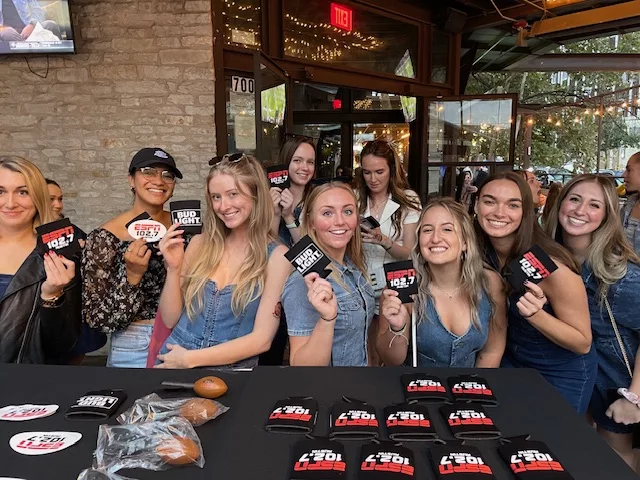 A large crowd gathers and poses with Swag at an ESPN Austin's Watch Party 2023