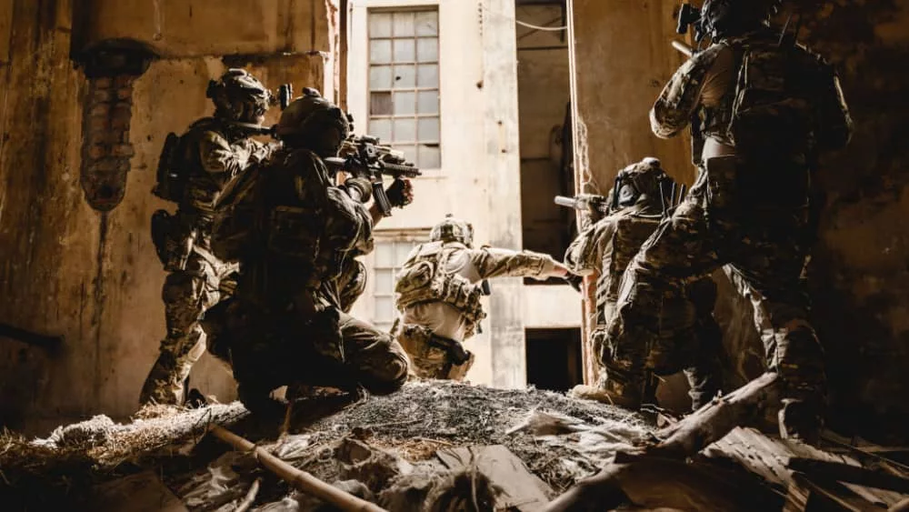 Expert team of soldiers with weapons attacking enemy