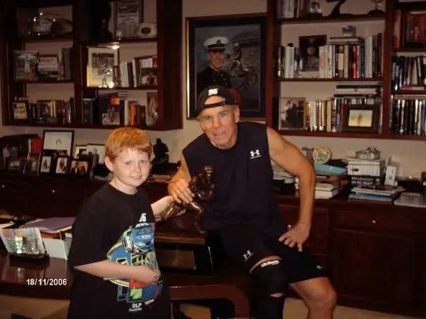 A 10 year old Trey Campbell with Roger Staubach in 2006, checking out Roger's Heisman Trophy.