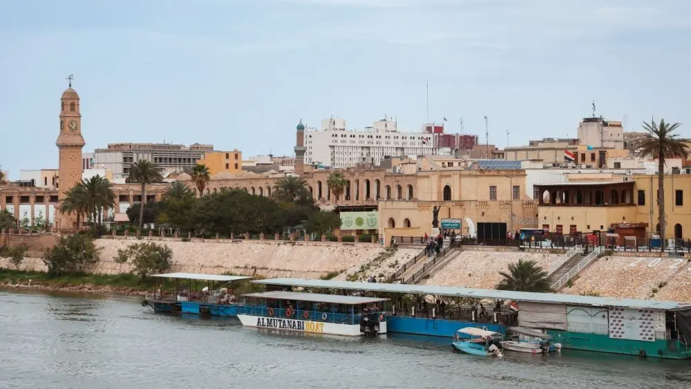 Historic buildings and riverboats on the Tigris River in Baghdad^ Iraq Baghdad^ Iraq - March 22^ 2025