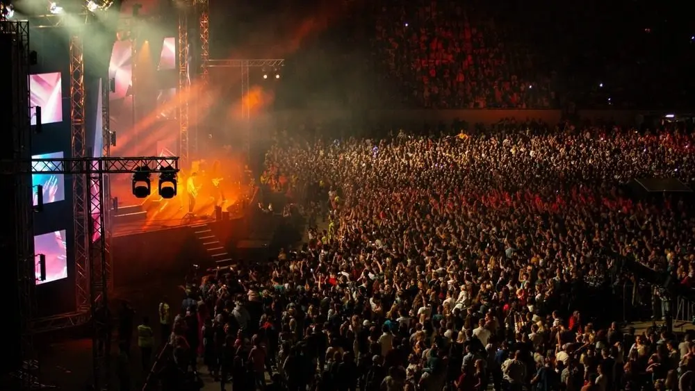 Large Concert Crowd and Stage Lighting in a Stadium at Night