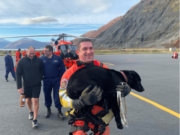 coast-guard-petty-officer-1st-class-rafael-aguero-a-rescue-swimmer-with-air-station-kodiak-carries-grace-an-8-month-old-puppy-who-was-presumed-lost-after-her-owners-vessel-ran-aground-near-black-poi-2