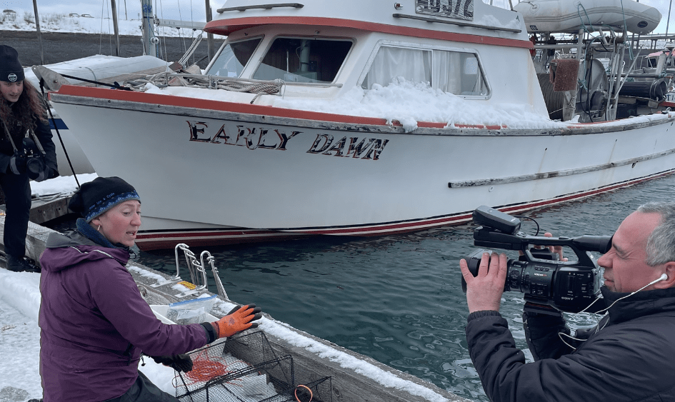 UAA students and team film Jasmine Maurer, the harmful species lead at KBNERR as she checks her crab traps in the Homer harbor