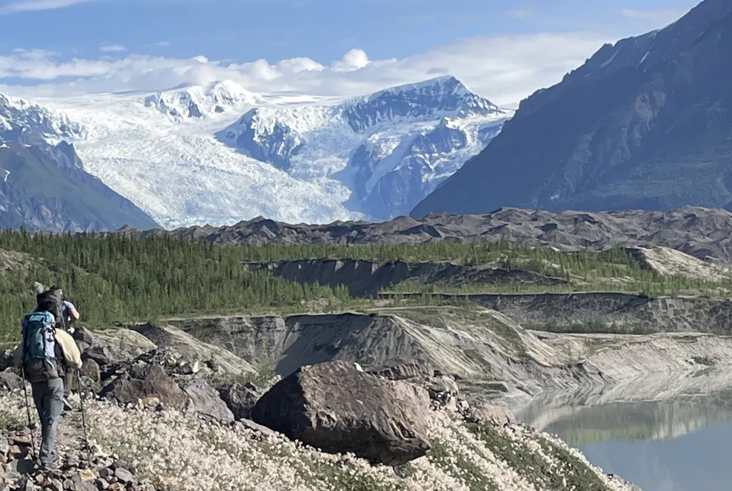 From left, Martin Truffer and Adam Bucki walk along the gravel moraine of Kennicott Glacier on an 11-hour hike to reach Fireweed rock glacier. Photo by Ned Rozell.