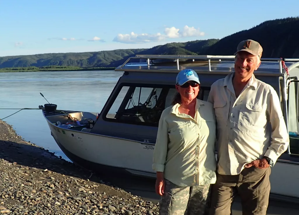 Chris Florian, left, and Skip Ambrose pose on the bank of the Yukon River during a trip to monitor peregrine falcon nests in July 2018. Photo by Ned Rozell.