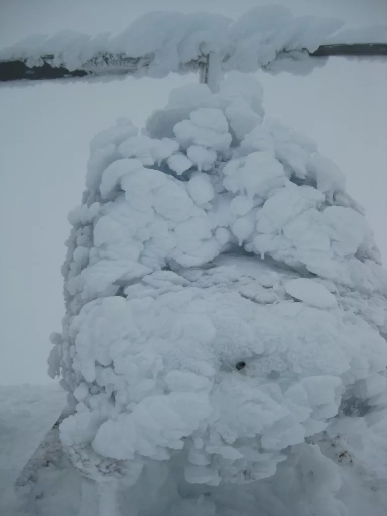 Ice coats a Jet Ranger helicopter that became stranded on the summit of Mount Mageik near the Valley of 10,000 Smokes in early September 2013. Sam Egli, the owner of the helicopter, later flew up with another helicopter and a mechanic who thawed this helicopter. Egli eventually flew this helicopter back to his base in King Salmon. Photo by Taryn Lopez.