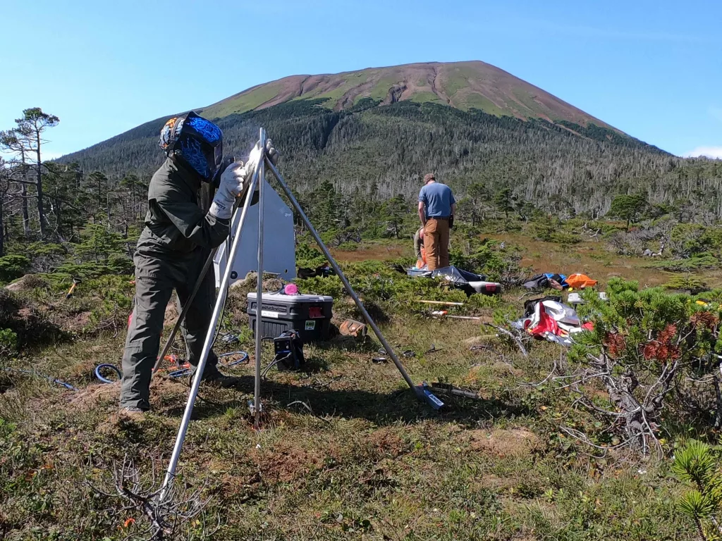 Alaska Volcano Observatory field technician Max Kaufman welds a new GNSS antenna monument at one of the observatory's new volcano monitoring sites on Mount Edgecumbe in late August 2023. Photo by Kax Kaufman..