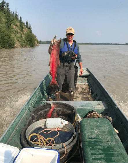 Ned Rozell holds up a king salmon caught on the Tanana River, a major tributary of the Yukon, in July 2019, when some fishing was still allowed. Photo by Sam Bishop.