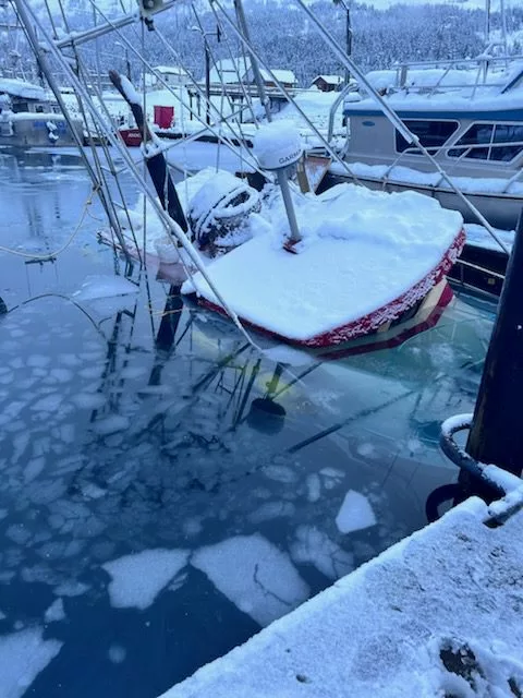 Boat sinking under snow weight
